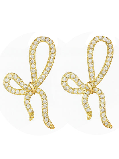 Lightweight gold necklace and earrings set featuring bow-knot pendants encrusted with crystals