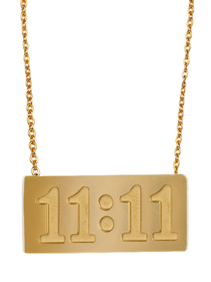 Close-up of a high-quality gold chain with pendant featuring the numbers 11:11 engraved on a rectangular bar