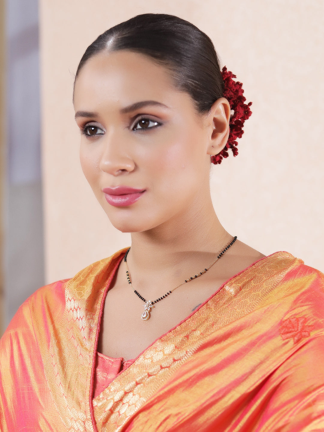 Model wearing a modern mangalsutra design with a delicate black-bead chain and stylish pendant