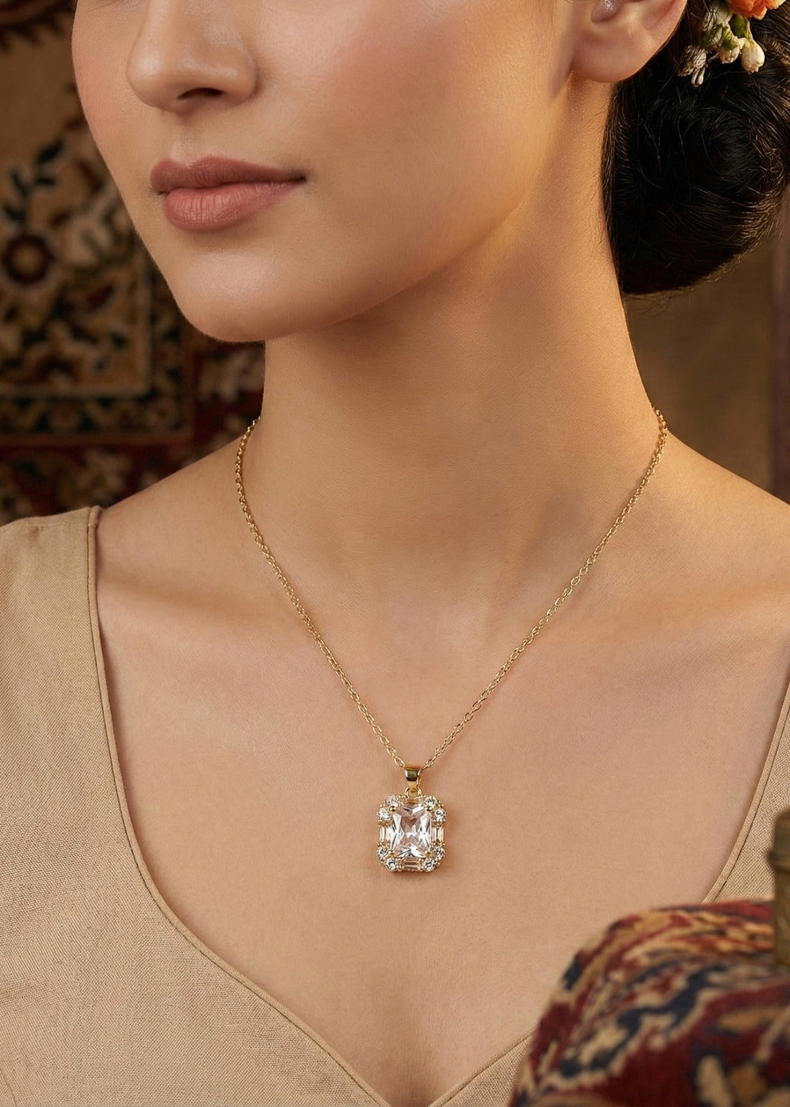 Close-up of a modern gold necklace design for women featuring a large emerald-cut crystal pendant with a halo setting.