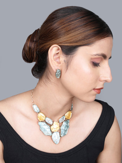 Side view of a model wearing modern gold necklace designs with matching earrings.