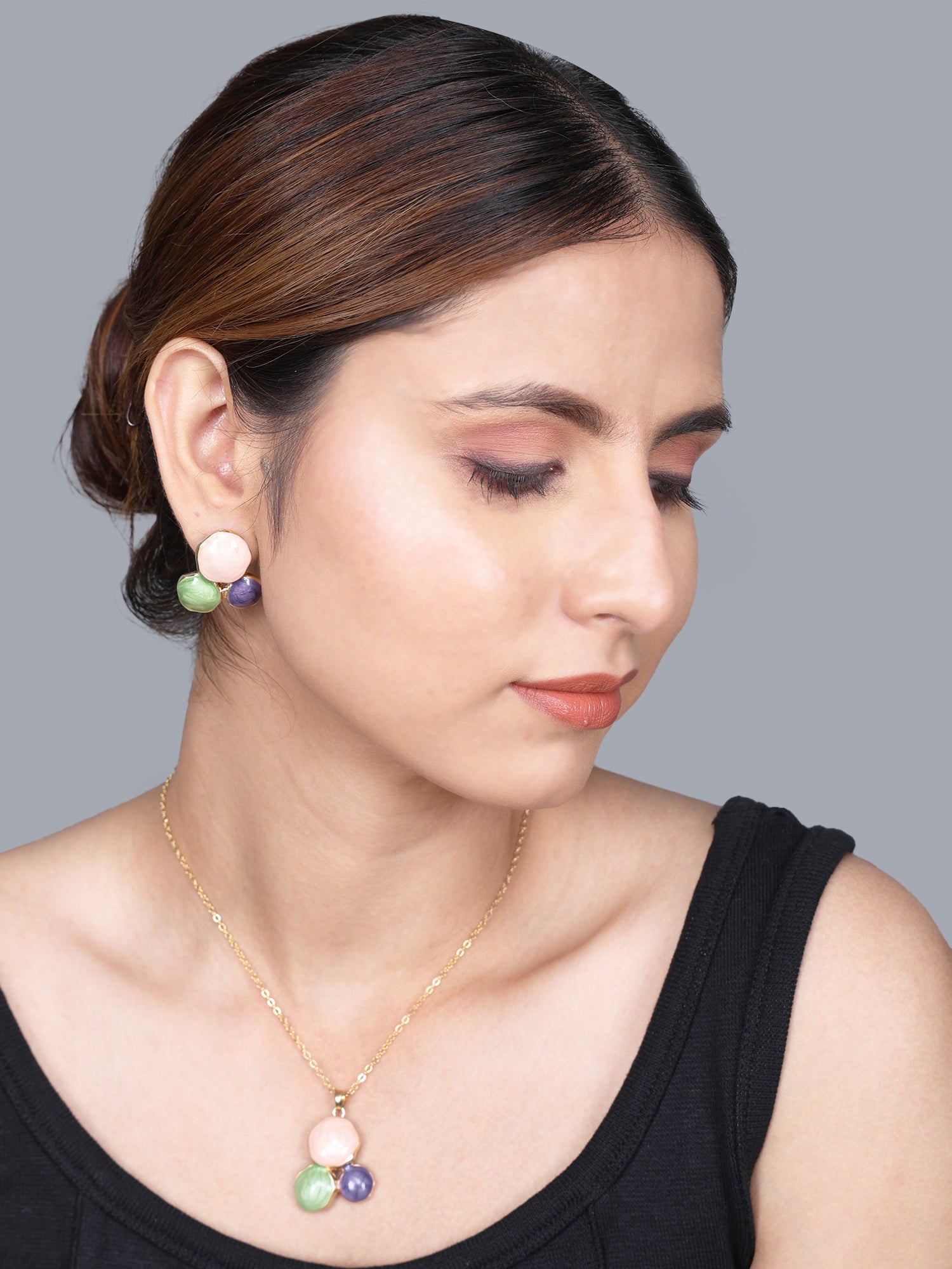 Modern gold necklace designs featuring a stylish gold plated necklace and earring set worn by a model