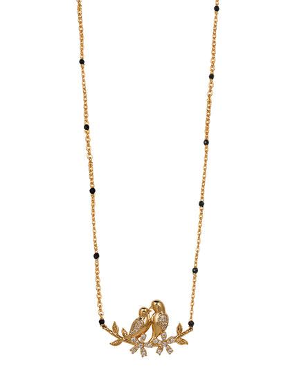Close-up of a new traditional mangalsutra design combining classic black beads with a modern, gold love bird motif pendant