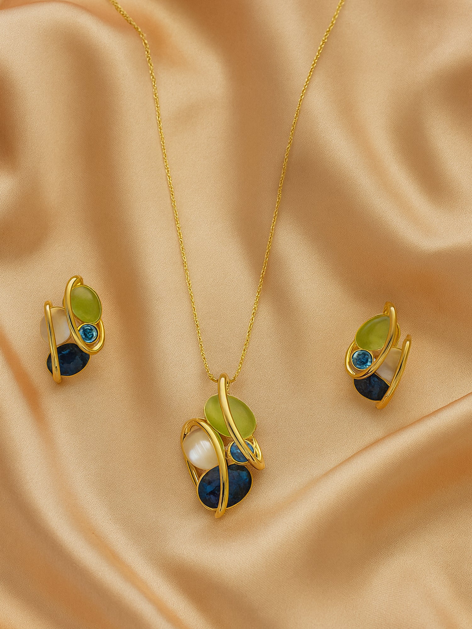 Modern gold necklace and earring set with artistic gemstone detailing