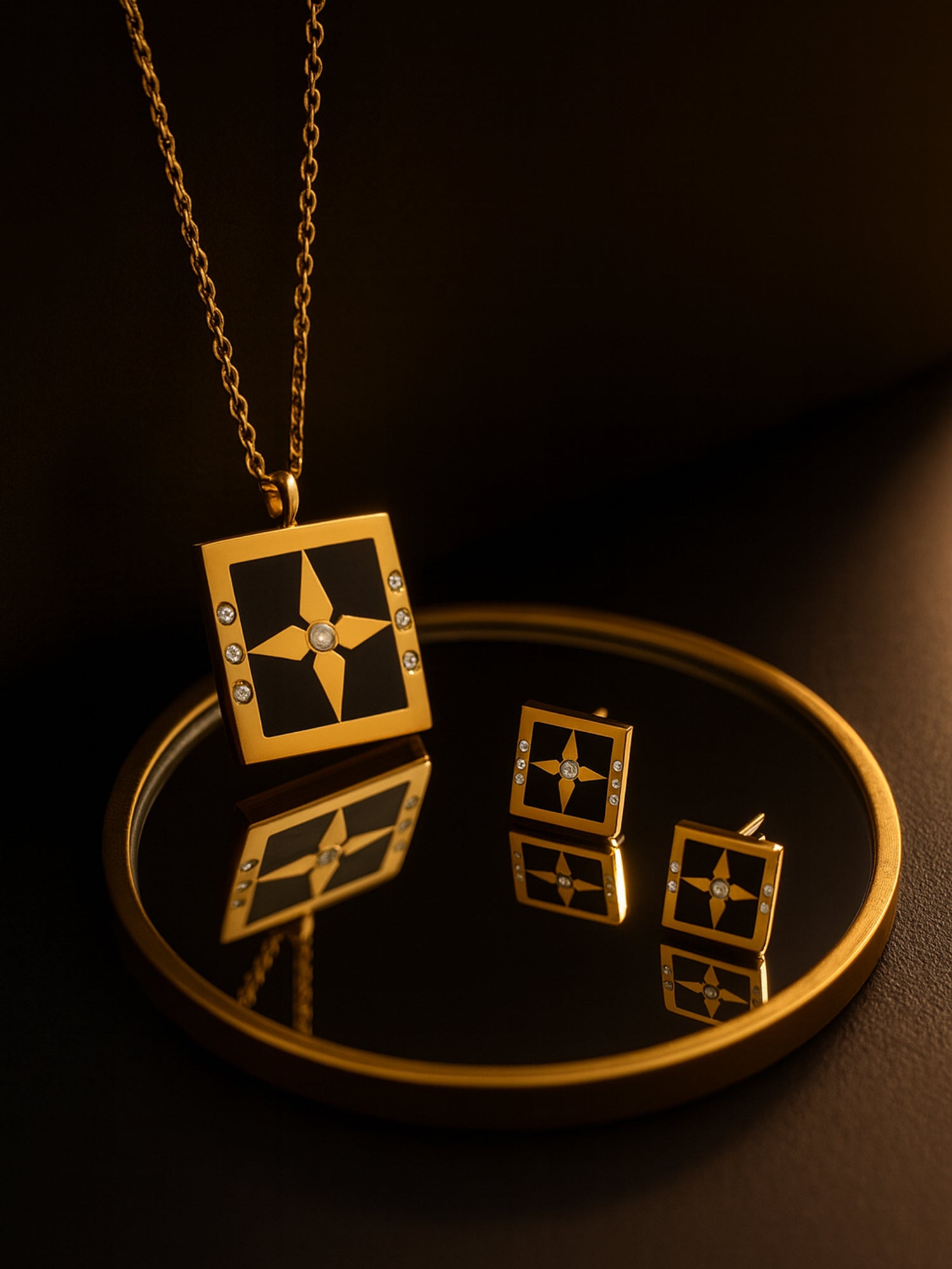 Gold necklace design featuring a square pendant with a star accent and matching stud earrings