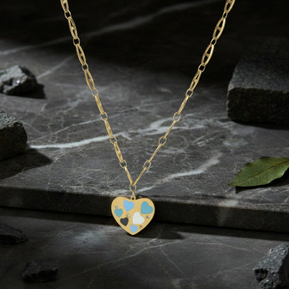 Necklace pendant designs gold finish with a multi-heart enamel charm displayed on a dark marble stone background.