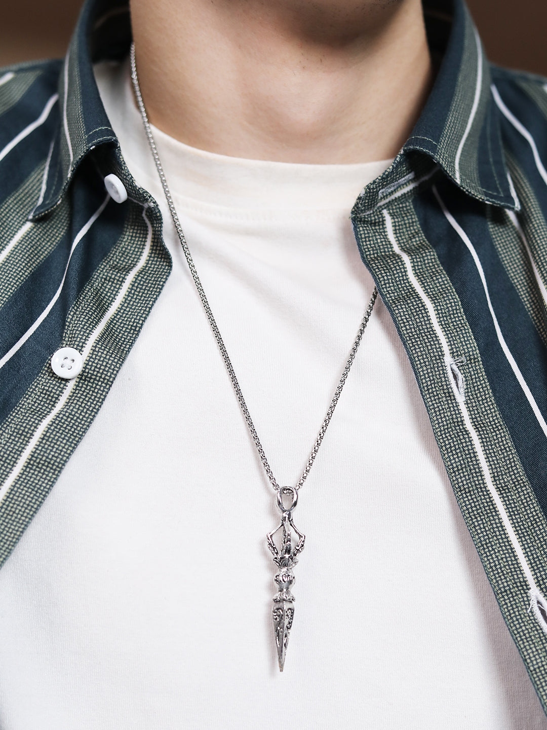 Silver chain necklace for guys with detailed pendant on casual outfit