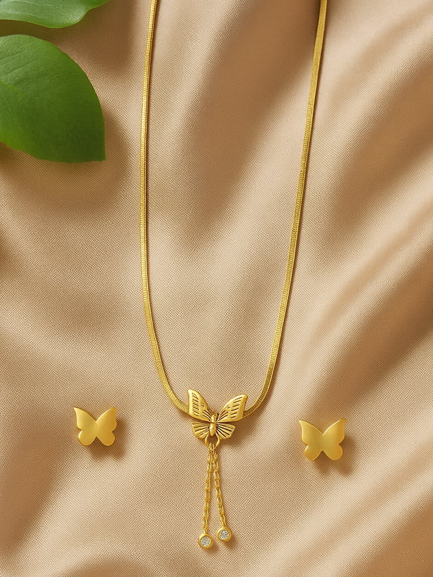 Elegant gold necklace and earring set with butterfly pendant design