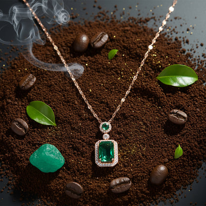 Modern mangalsutra design with an emerald pendant displayed over coffee grounds and green leaves