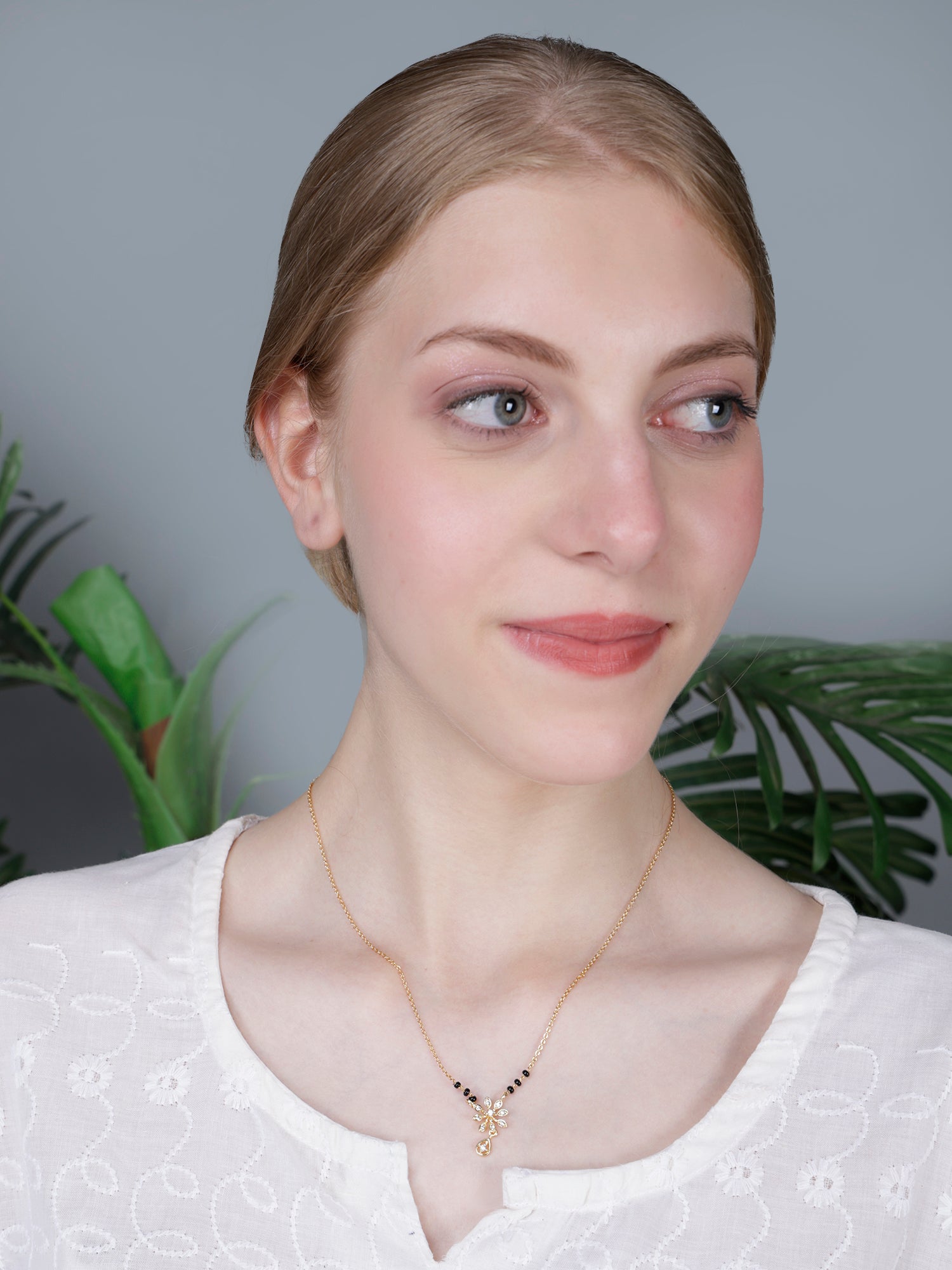 Chic and minimal gold trending mangalsutra designs featuring a stylish flower motif and a sparkling drop