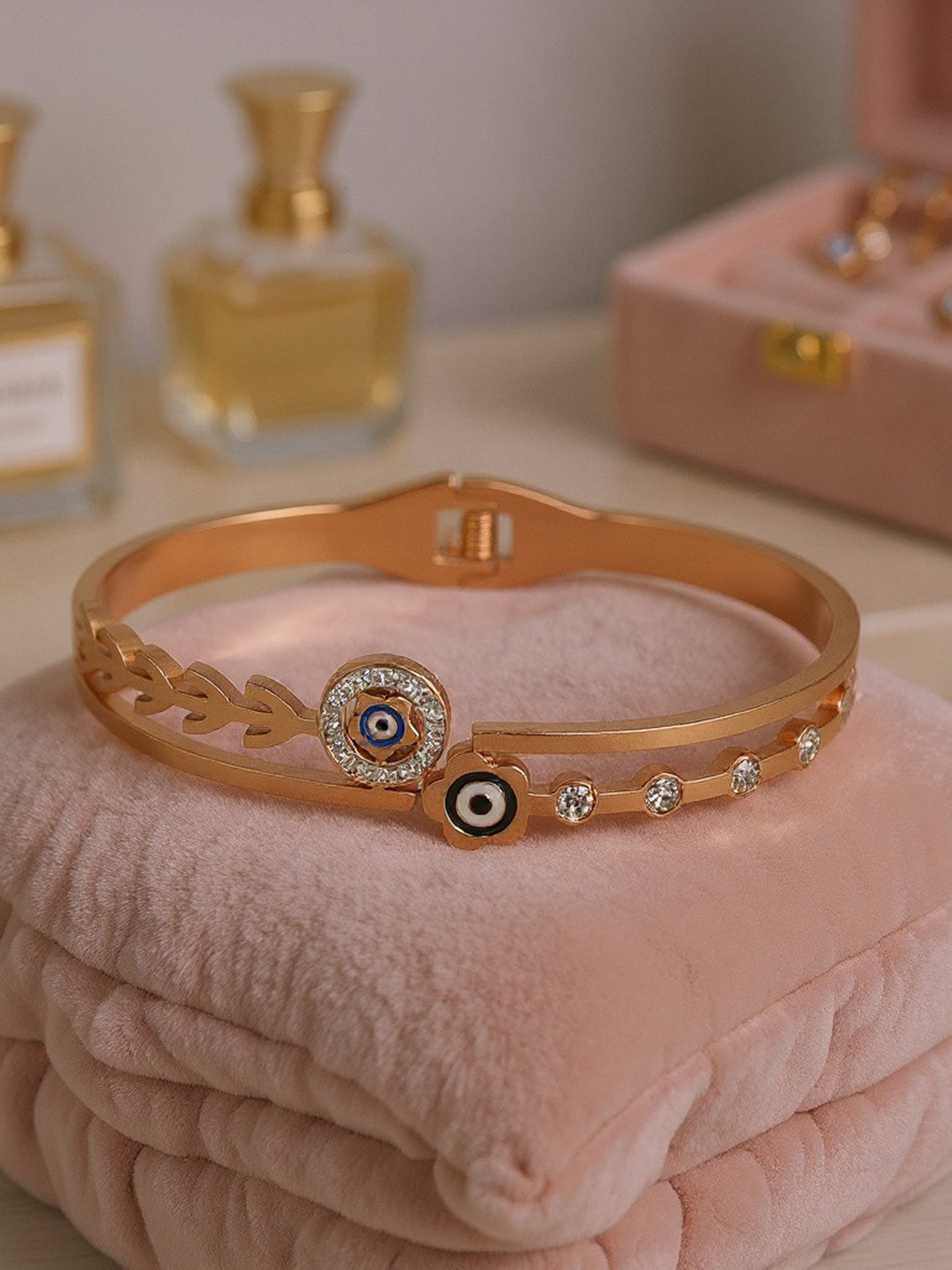 Elegant gold plated bracelet for ladies displayed on a velvet cushion, showcasing its intricate dual-band detail.