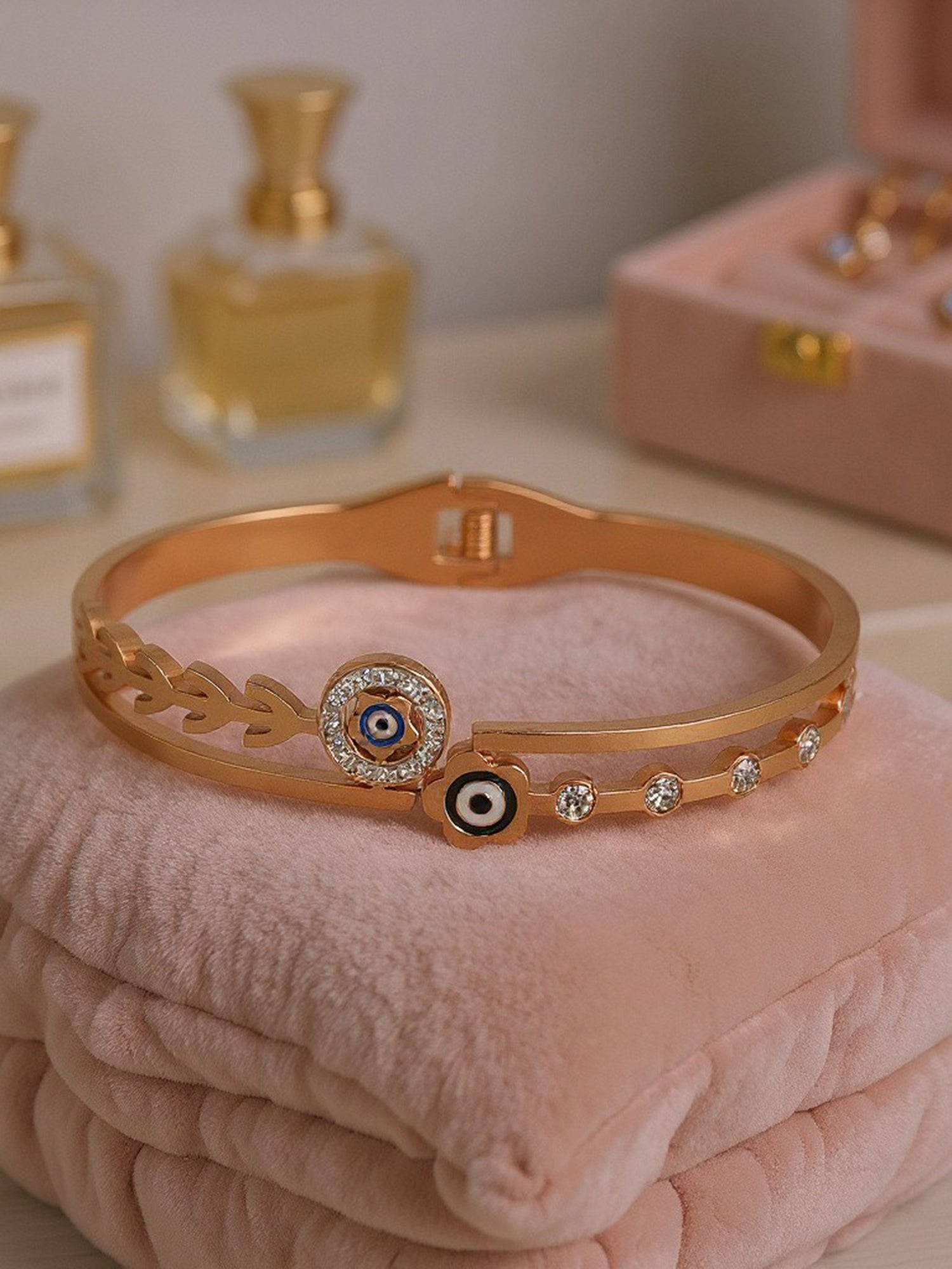 Elegant gold plated bracelet for ladies displayed on a velvet cushion, showcasing its intricate dual-band detail.