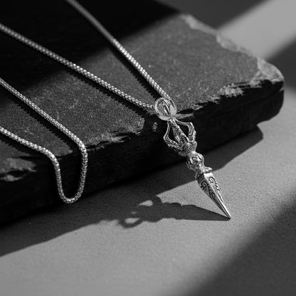 Silver chains for men with detailed pendant on a textured dark surface