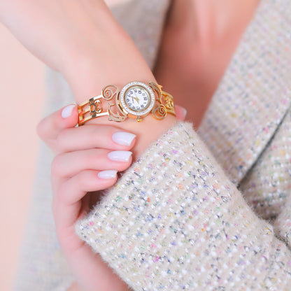 A simple bracelet for women with elegant filigree work and a sparkling crystal bezel watch face.