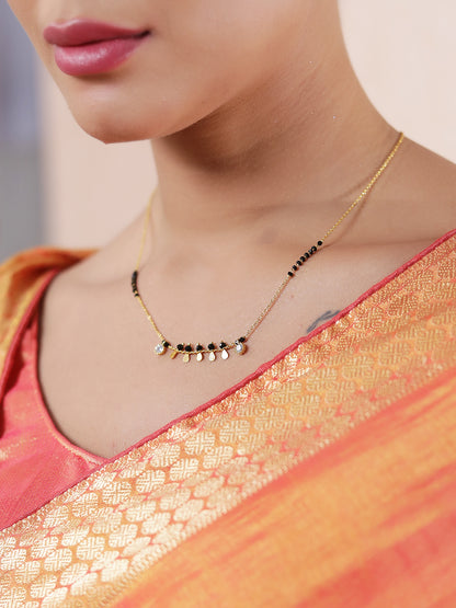 Latest gold mangalsutra design with black beads and small hanging gold charms