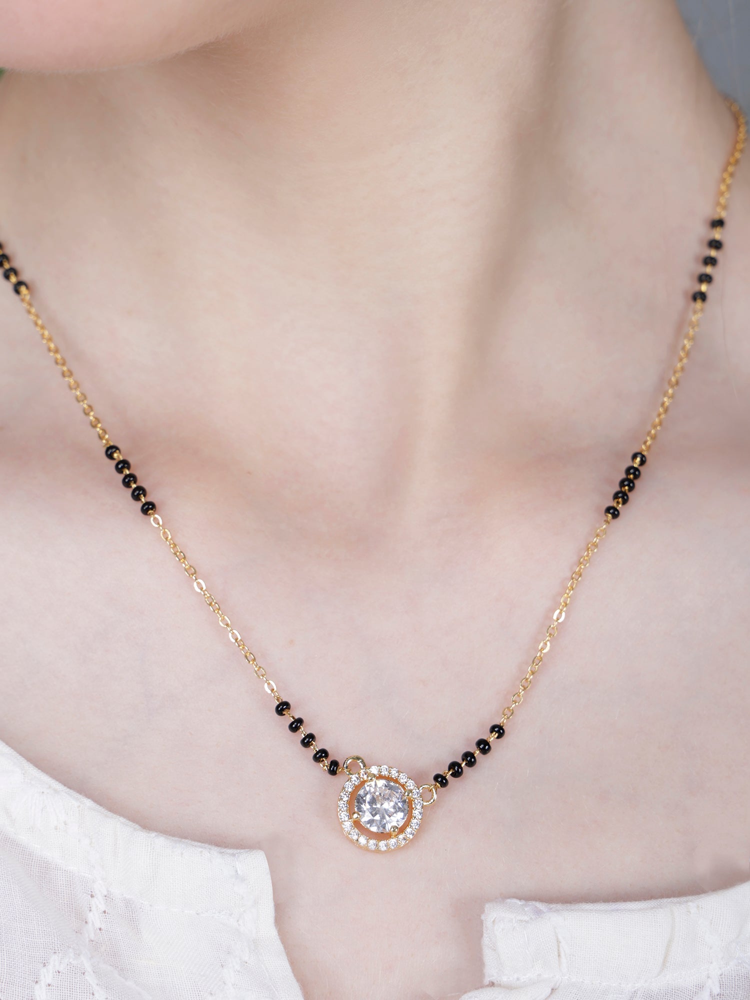 Trending mangalsutra design gold chain necklace with black beads and a sparkling round solitaire CZ pendant