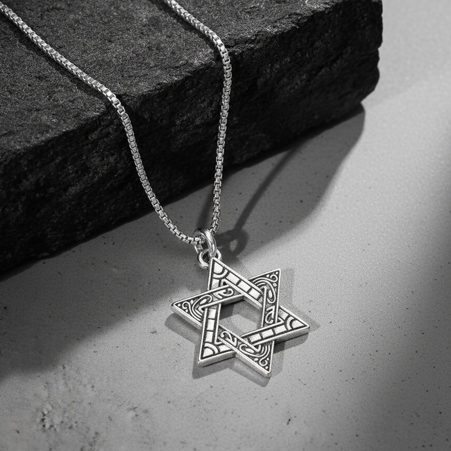 Silver pendant necklace with engraved star-shaped charm