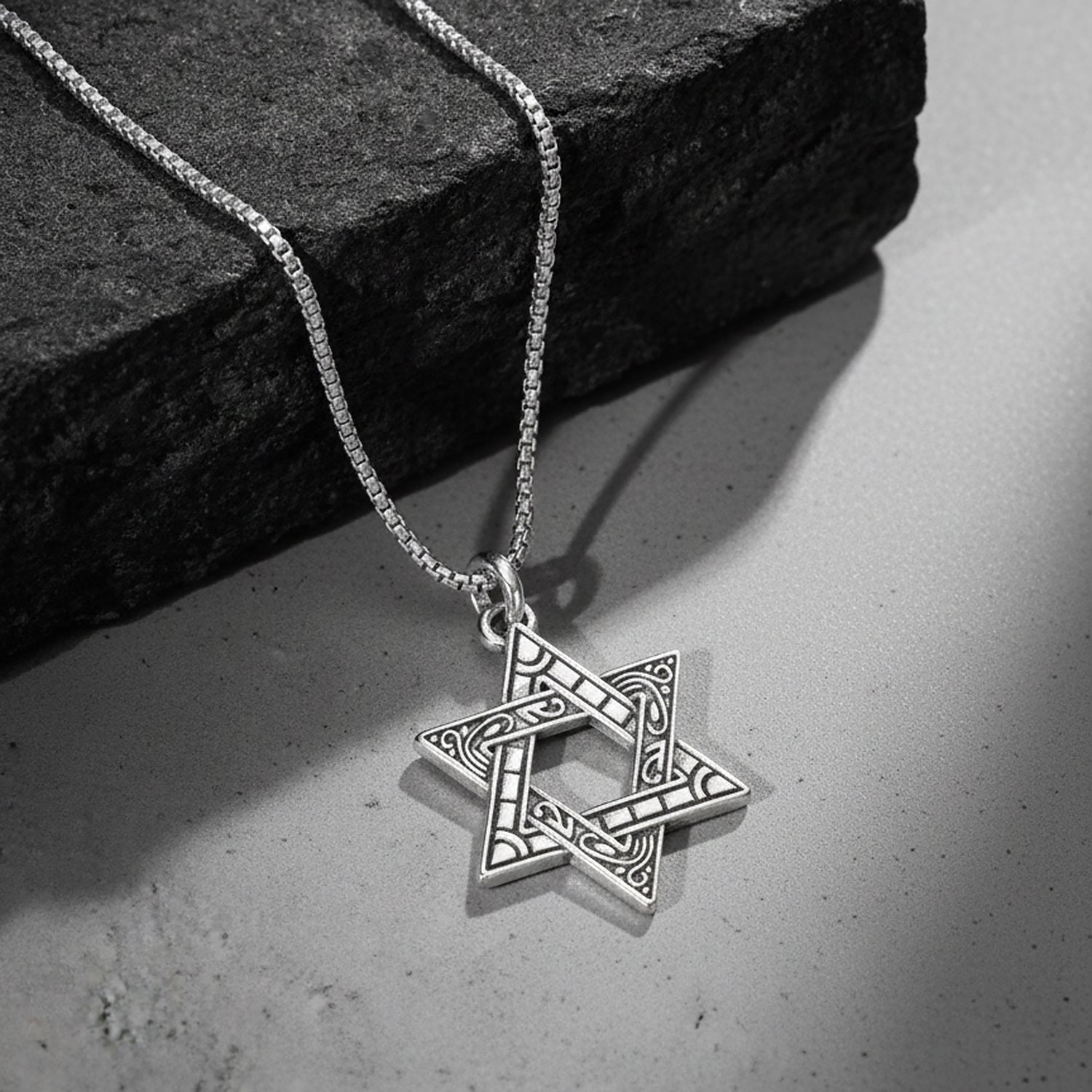 Silver pendant necklace with engraved star-shaped charm