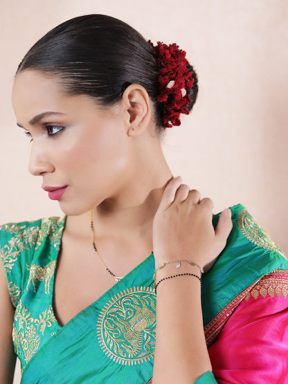 Modern mangalsutra design styled with a green and pink embroidered saree