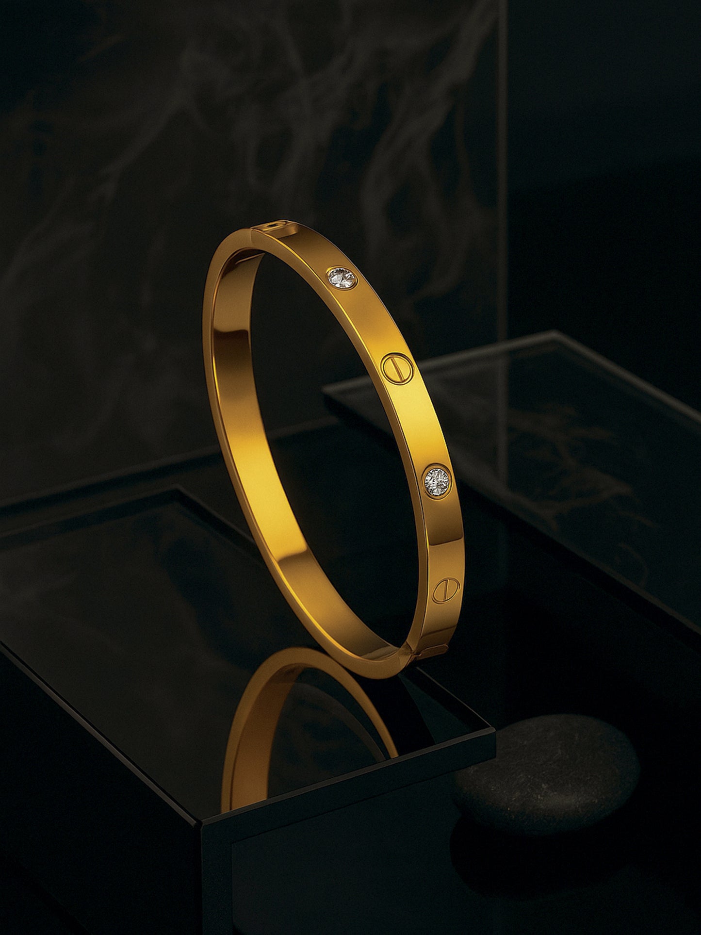 A stylish gold bracelet design for women featuring embedded crystals, displayed on a reflective black pedestal.