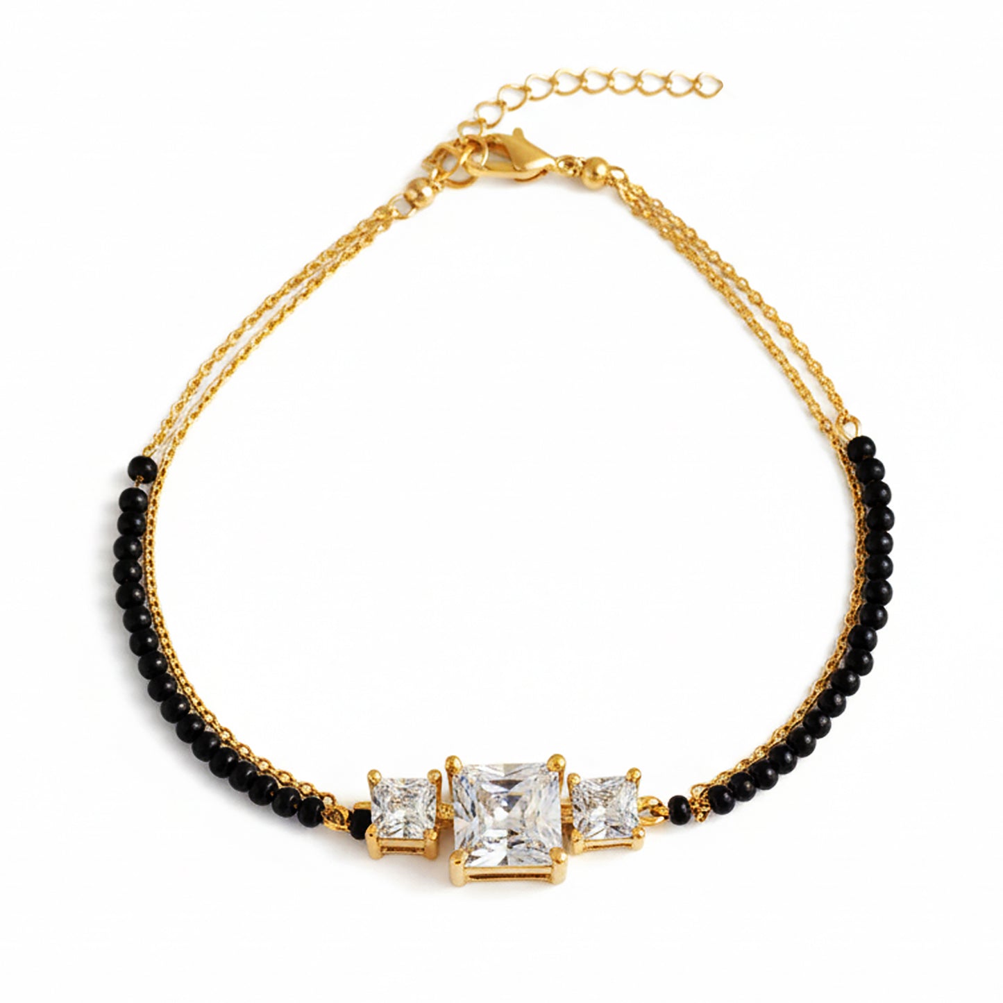 Stylish mangalsutra design bracelet with gold chain, black beads, and three stone centerpiece.