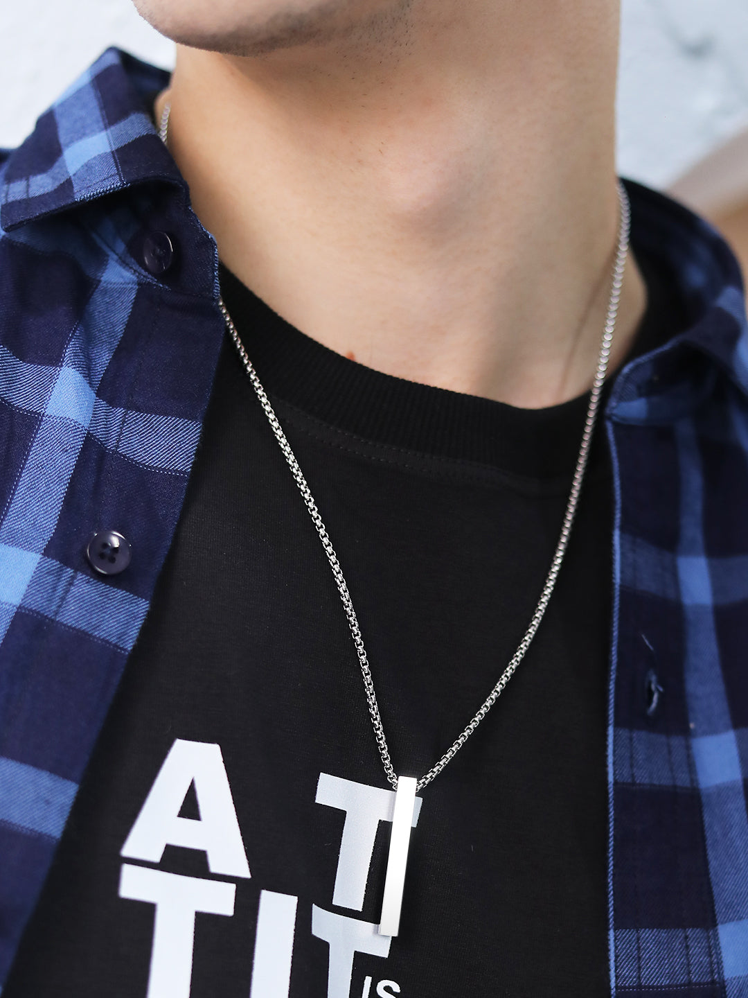Stylish pendant for men on a silver chain worn with a casual outfit