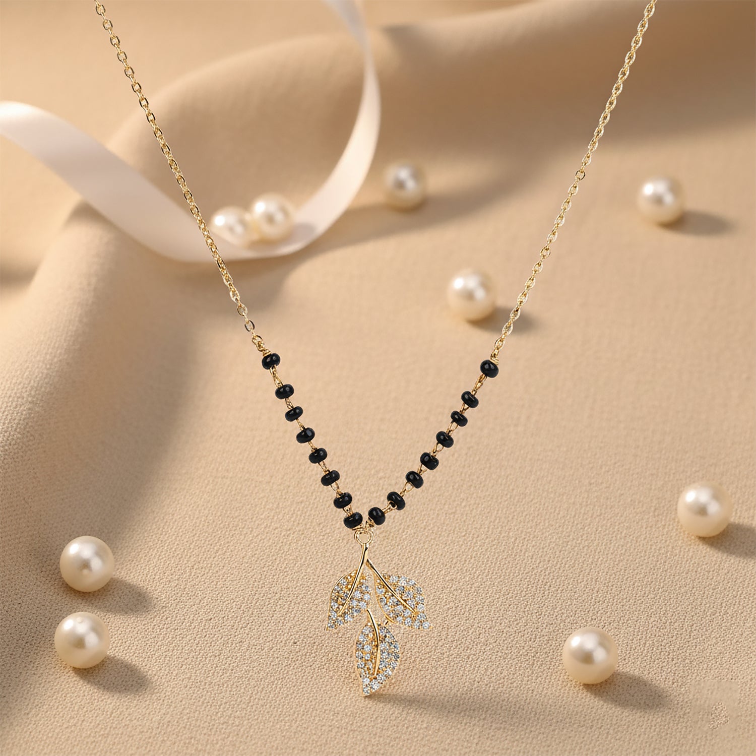 Trending mangalsutra design with gold chain, black beads, and crystal leaf pendant