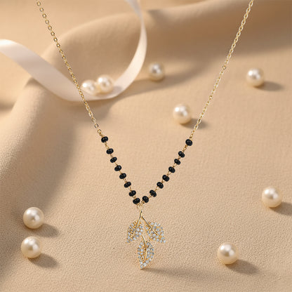 Trending mangalsutra design with gold chain, black beads, and crystal leaf pendant