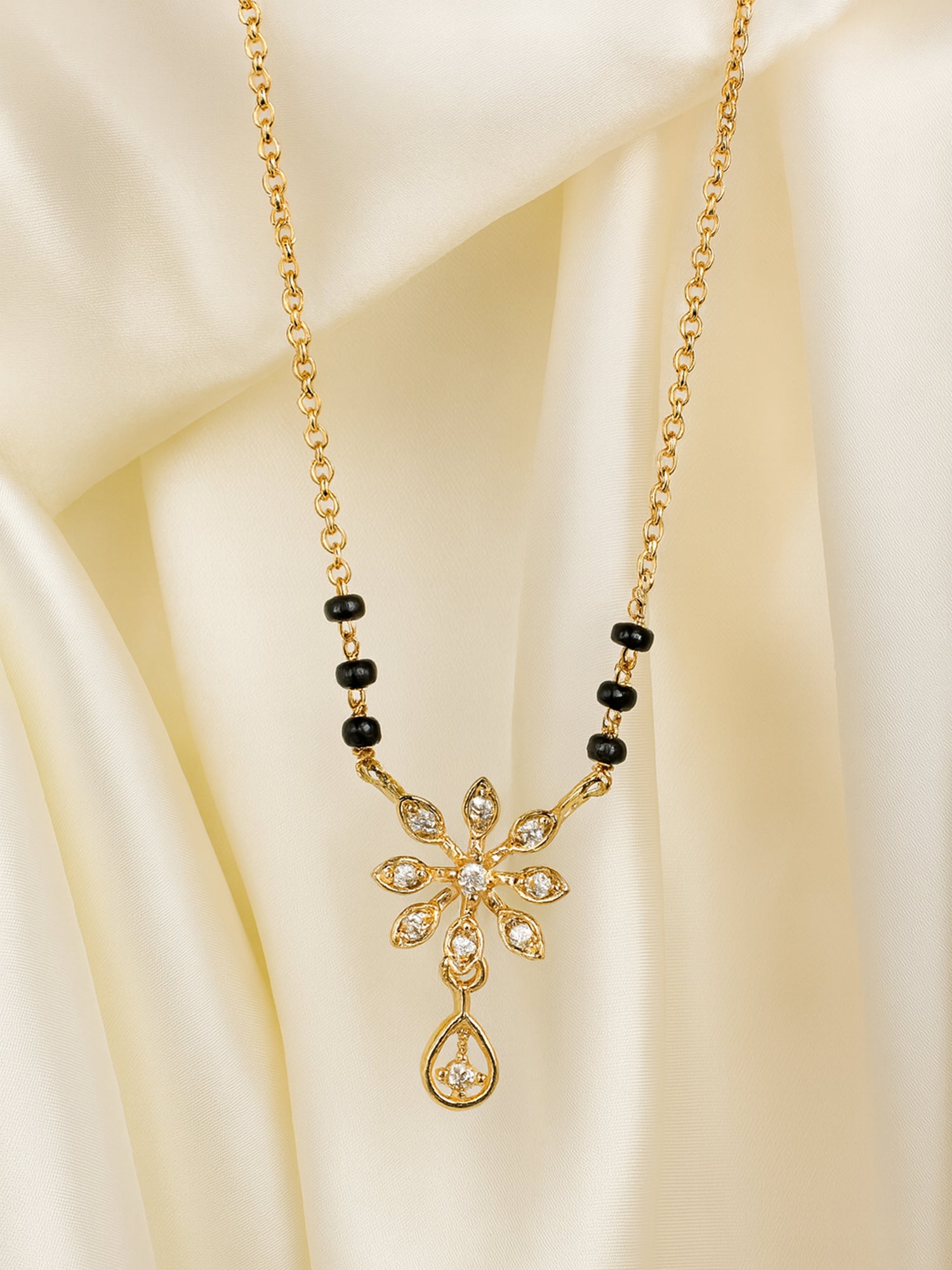 Elegant floral pendant gold mangalsutra design with diamond/CZ accents and black beads, perfect for daily wear.