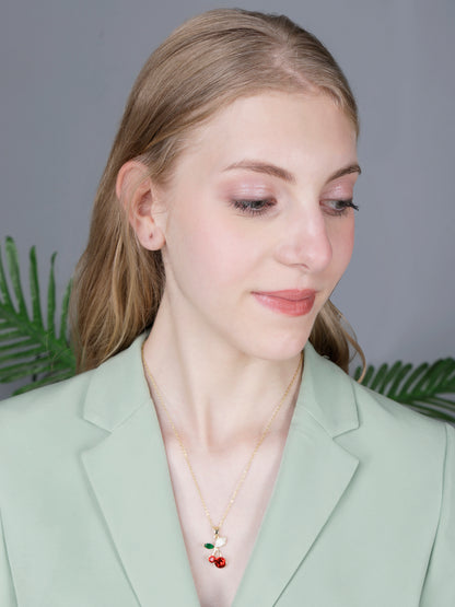 A professional look styled with gold long necklace designs and a vibrant red crystal fruit pendant