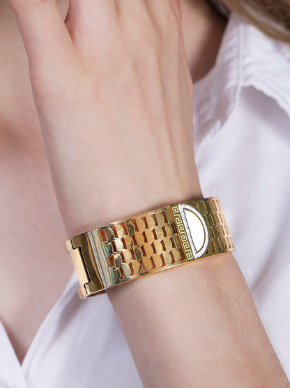Close-up view of a gold plated bracelet for ladies featuring a Greek-key pattern and luxury detailing.