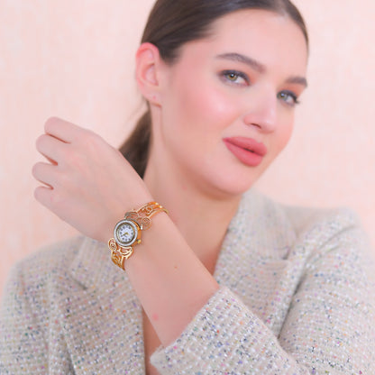 Close-up of a hand bracelet for women in gold finish paired with a professional tweed blazer.