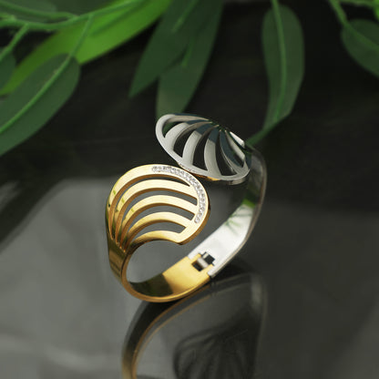 Latest bracelet design featuring a unique dual-tone gold and silver wave pattern with crystal accents on a dark reflective surface.