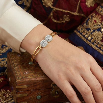 Stylish gold bracelet design for women with a double square crystal charm on the wrist