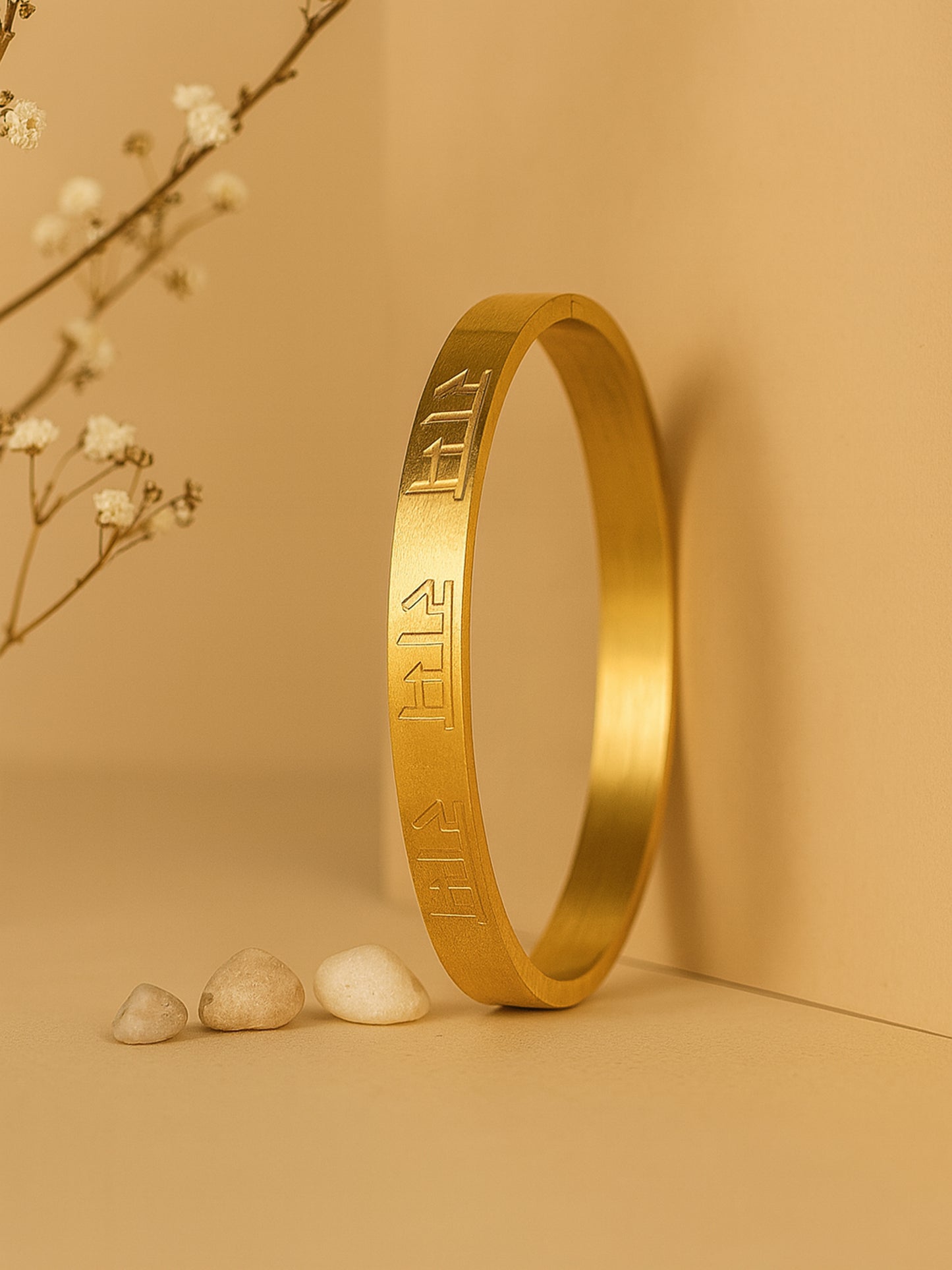 Vertical shot of a stylish bracelet for women standing against a warm beige background.