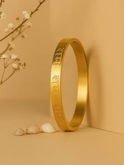 Vertical shot of a stylish bracelet for women standing against a warm beige background.